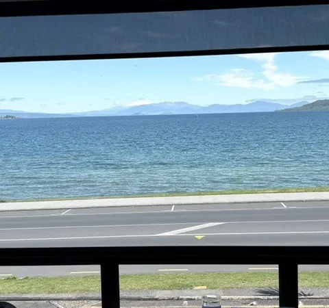 Blue water and mountains across Lake Taupō